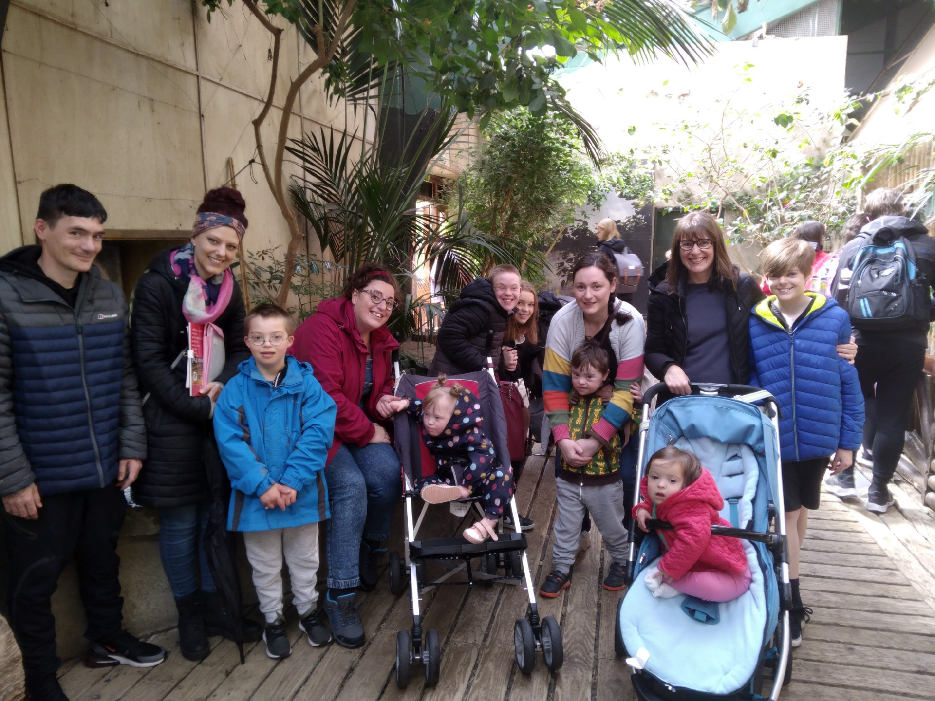 This is a photo of some parents and their children on a day out with Down Syndrome Cheshire at Chester Zoo which was funded by The Moulding Foundation.